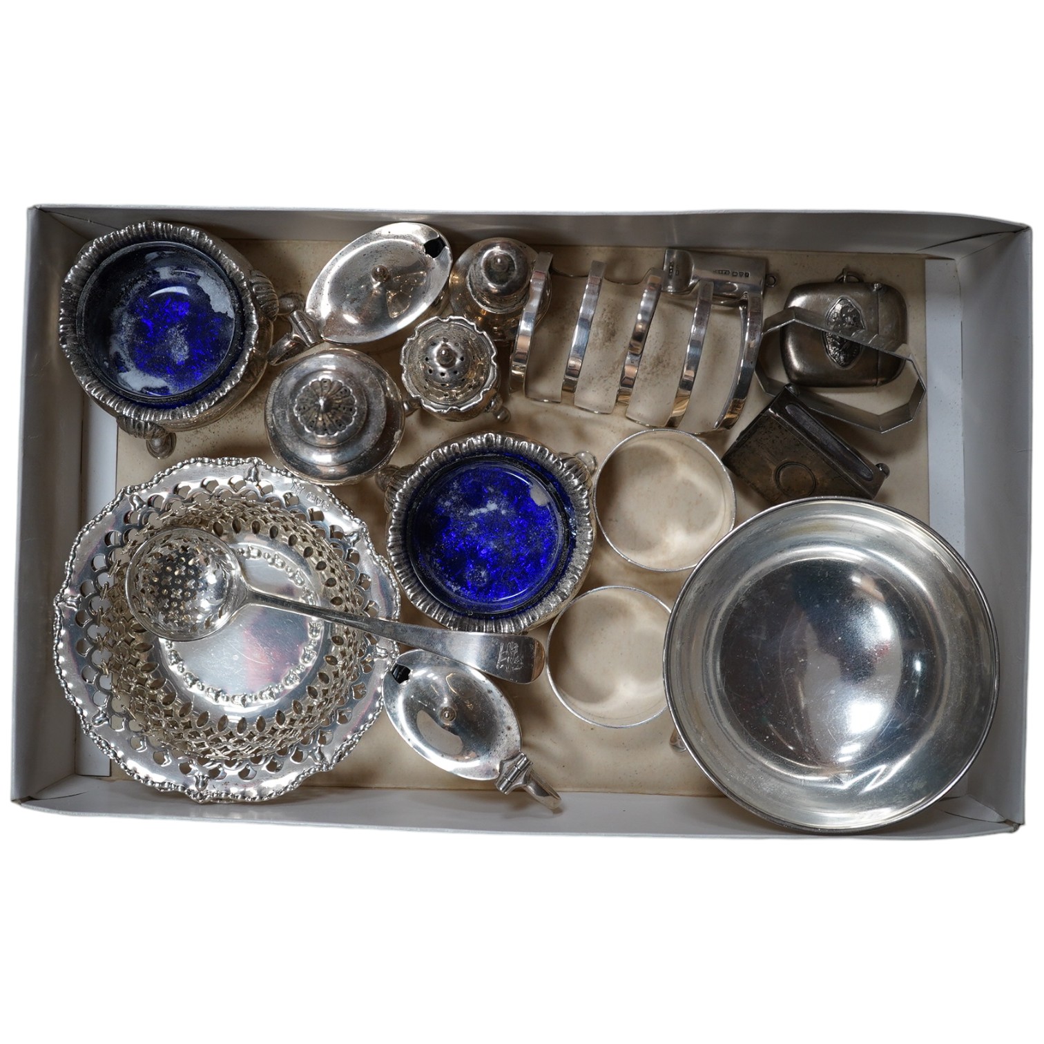 Sundry small silver including a pair of Edwardian pierced bonbon dishes, Chester, 1906, diameter 11cm, pair of Scottish bun salts, five other condiments, three napkin rings, two spoons, a bowl, toast rack, whistle match